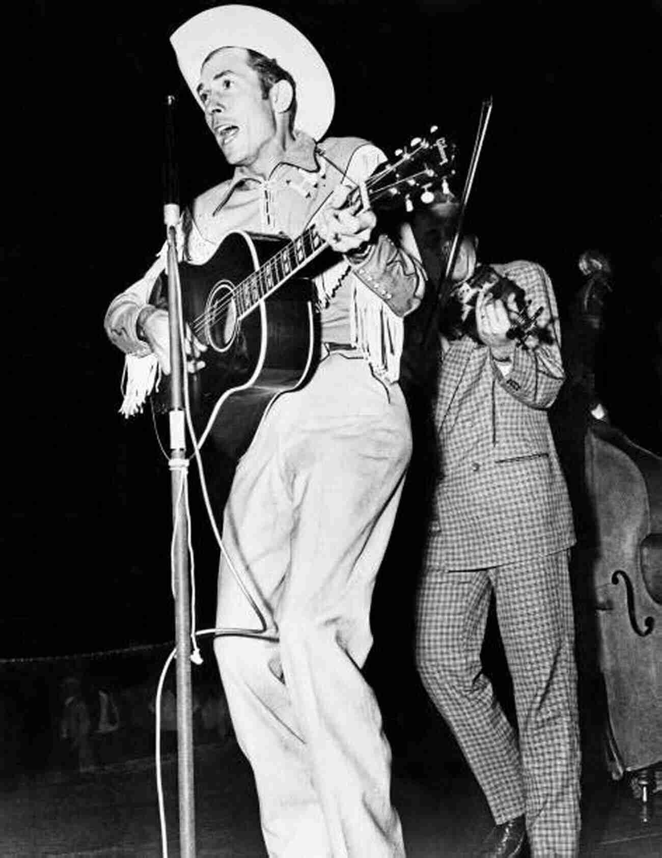 Hank Williams Performing On Stage In A Cowboy Hat With His Guitar Hank: The Short Life And Long Country Road Of Hank Williams