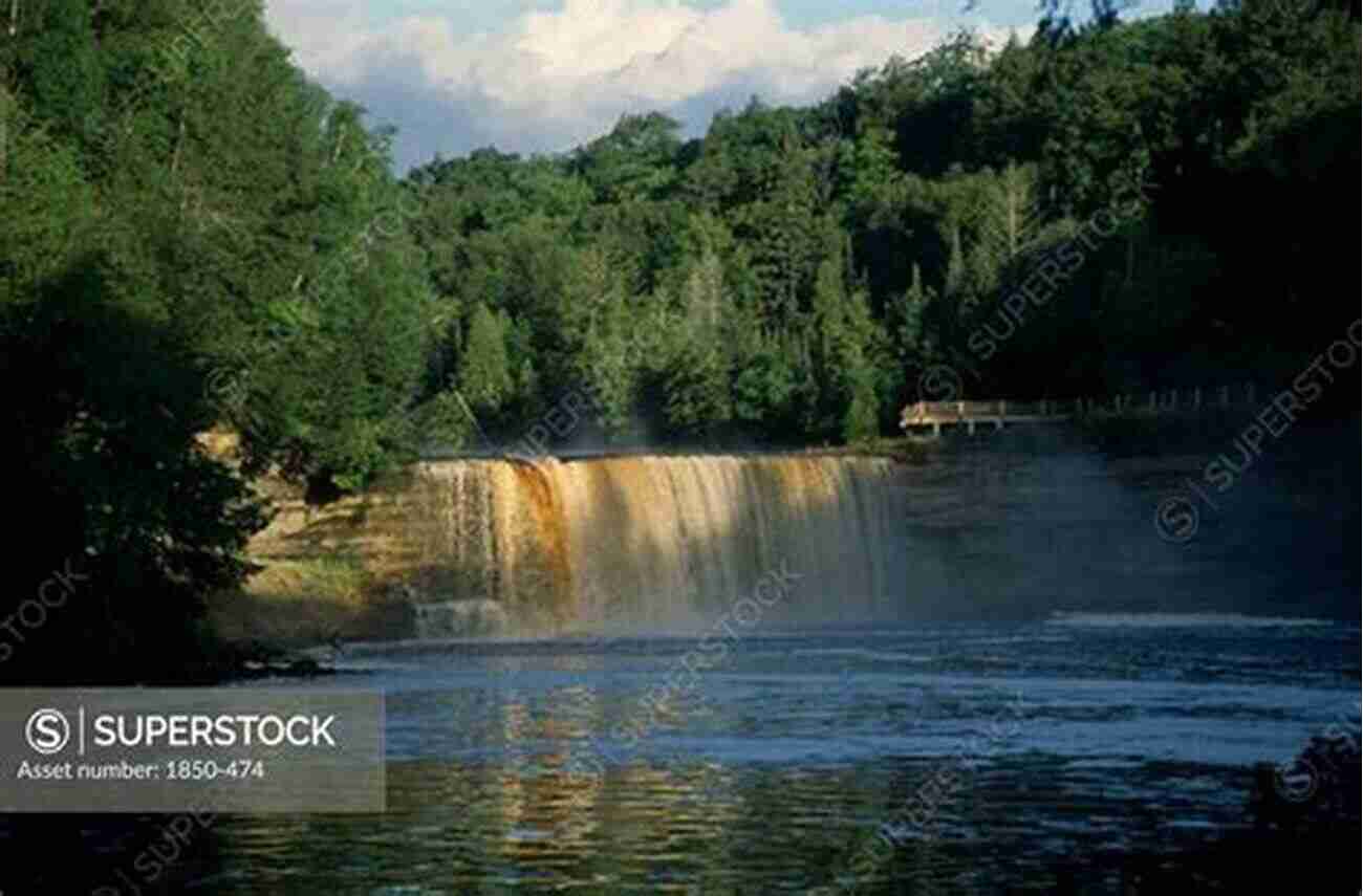 The Magnificent Tahquamenon Falls Surrounded By Lush Greenery Michigan Bucket List Adventure Guide: Explore 100 Offbeat Destinations You Must Visit